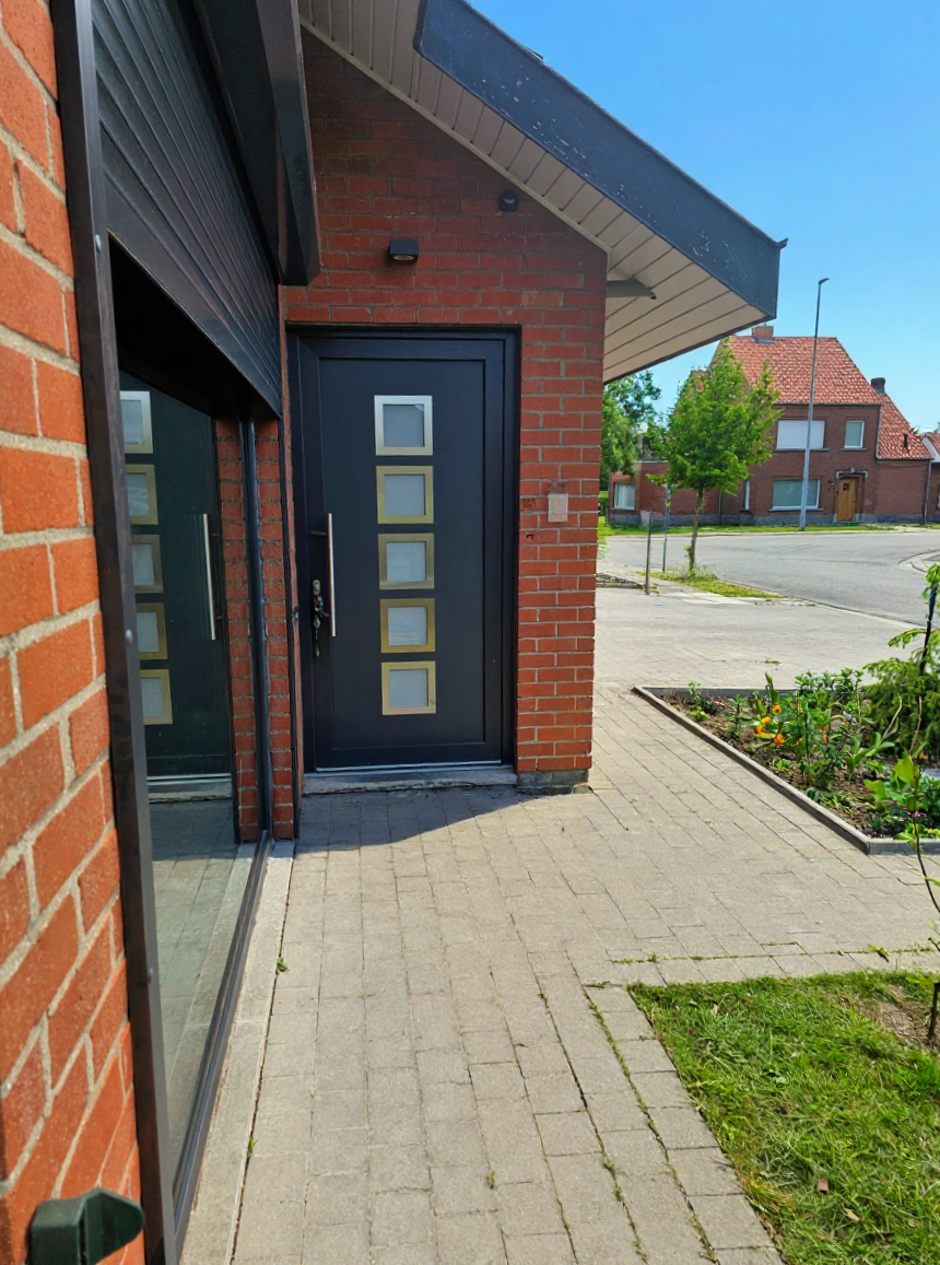 Close-up of the high-security entrance door with satin vertical pull handle