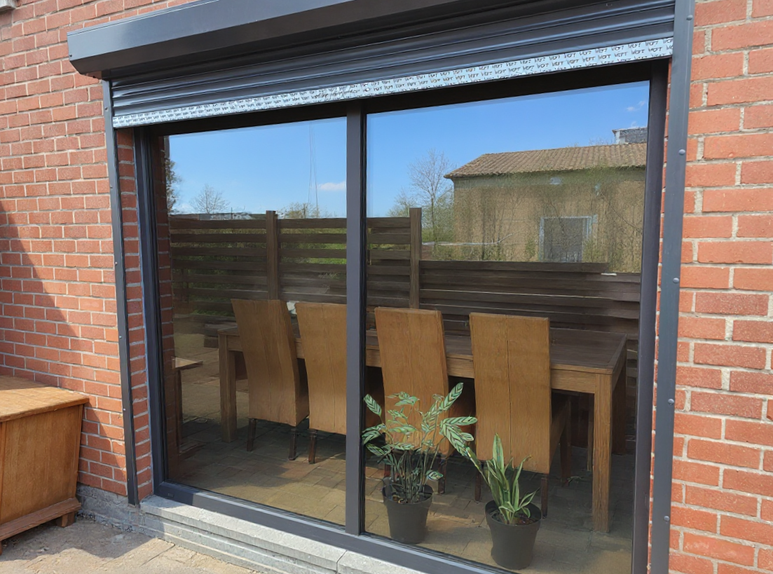 Wide sliding door and roller shutter leading to the garden terrace